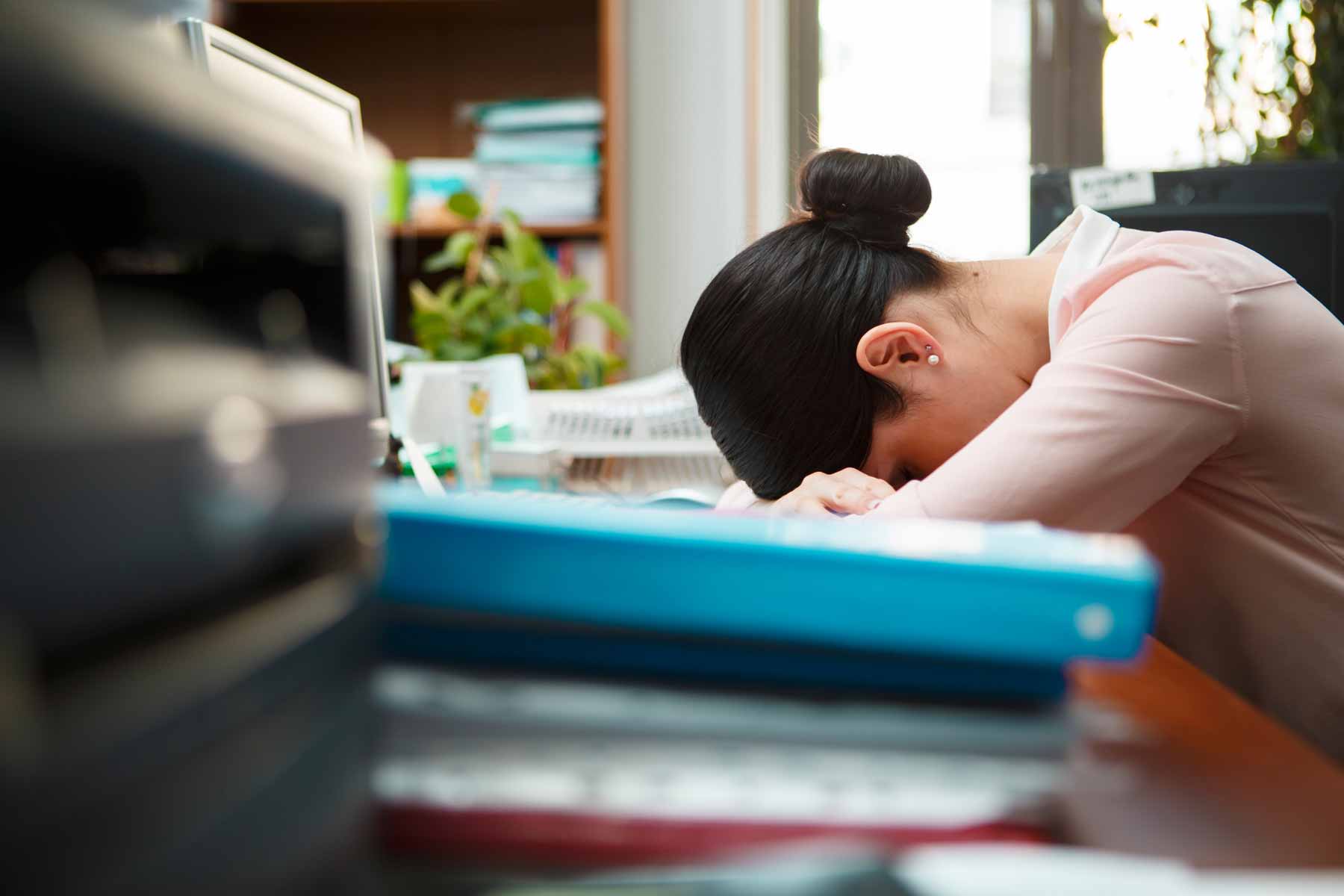 woman sleeping at work due to sleep loss